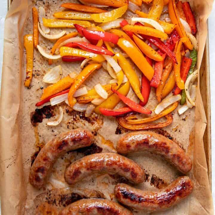 cooked italian sausages peppers and onions on a sheet pan