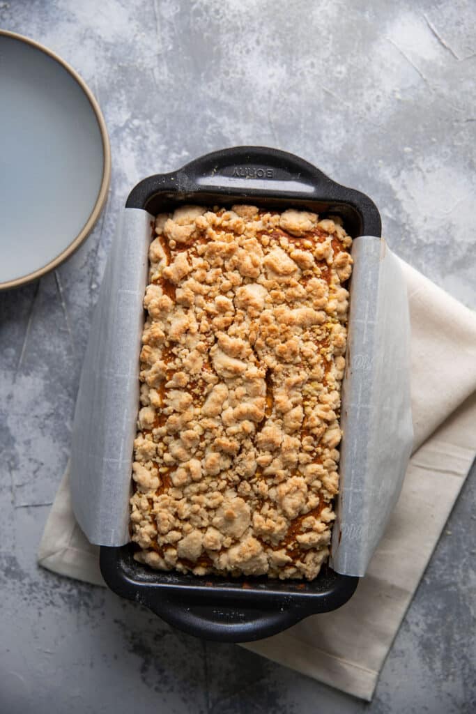 pumpkin loaf cooked in a loaf pan on top of a napkin