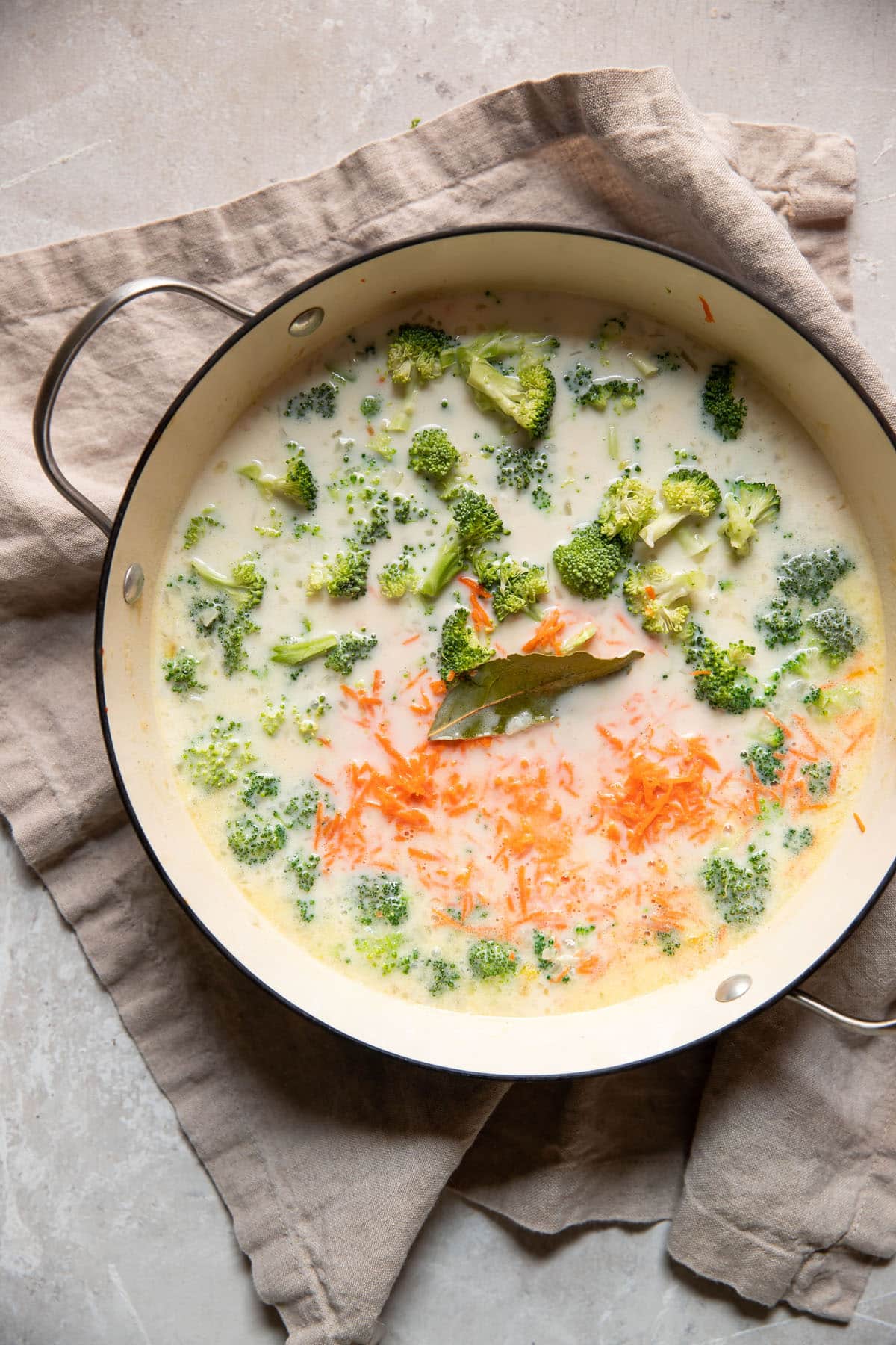 carrots broccoli in a pot with broth