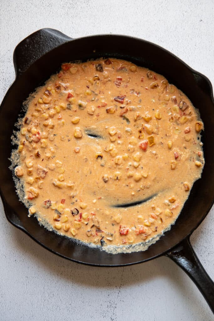 mexican street corn enchilada sauce in a skillet