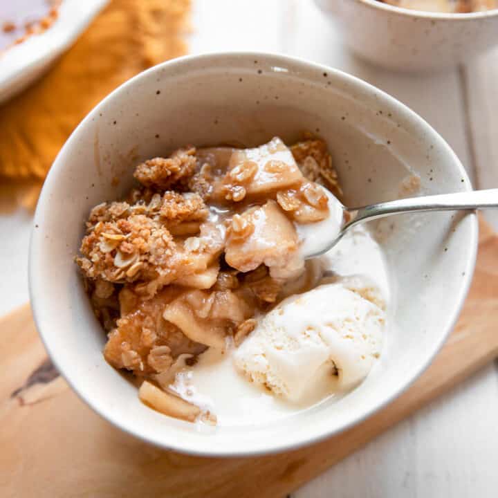 apple crisp in a bowl with a spoon.
