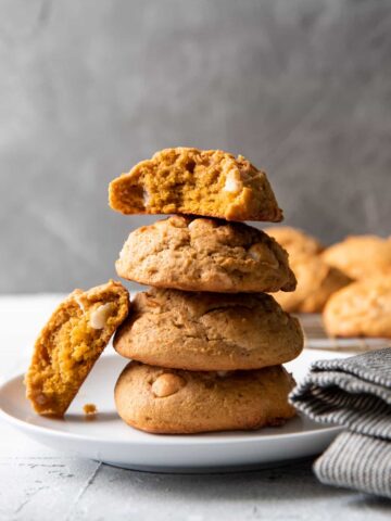pumpkin cookies stacked on a plate