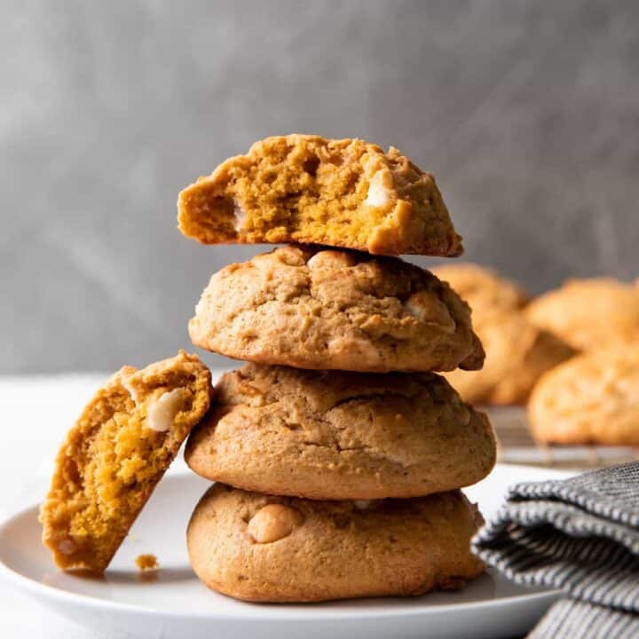 pumpkin cookies stacked on a plate