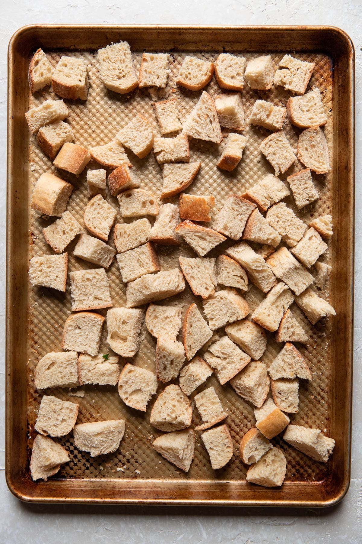 cooked cubes of bread on a pan