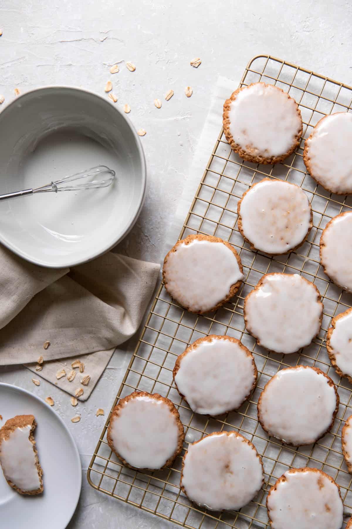 iced oatmeal cookies on a wire cooling rack.