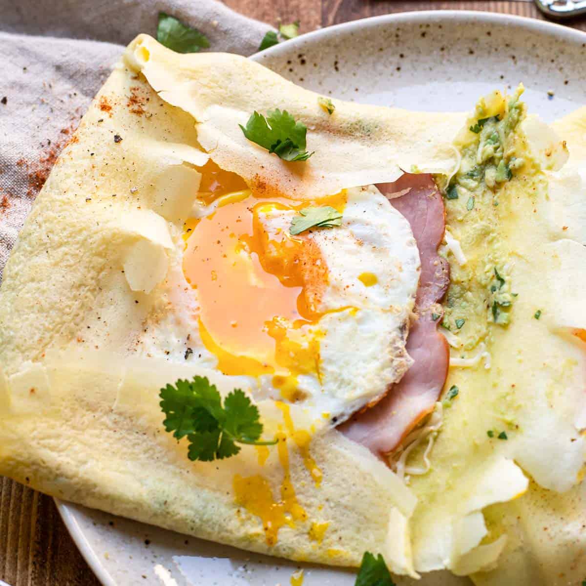 savory crepe with guacamole, jack cheese, ham and a sunny side up egg.