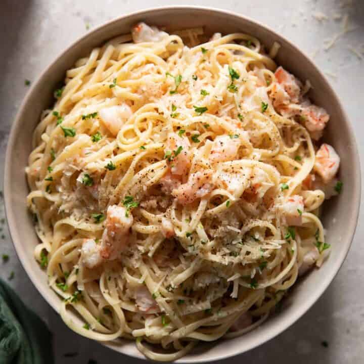 Shrimp scampi and linguine in a grey bowl.