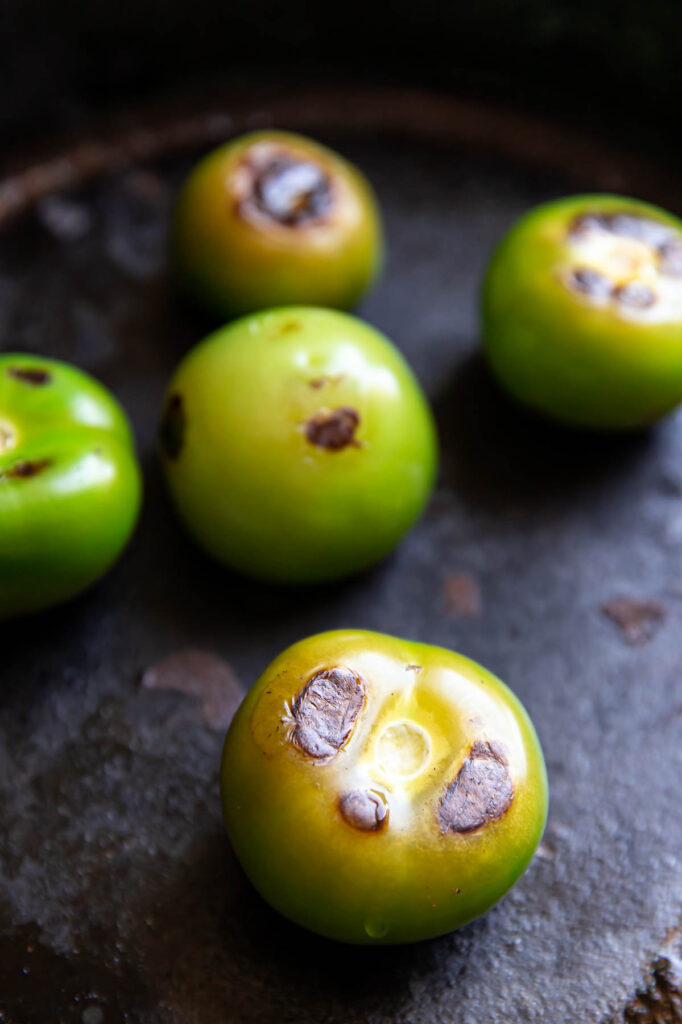 Tomatillos in a skillet.