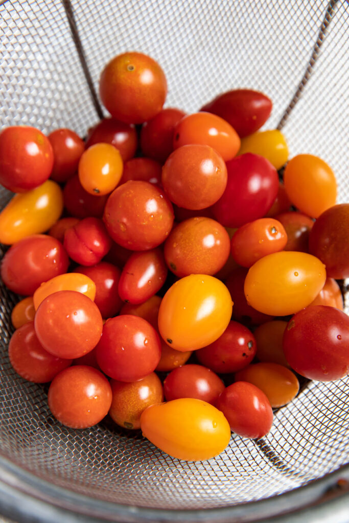 Colorful cherry tomatoes in a collander.