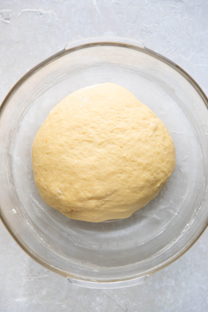 Orange roll dough in a bowl.