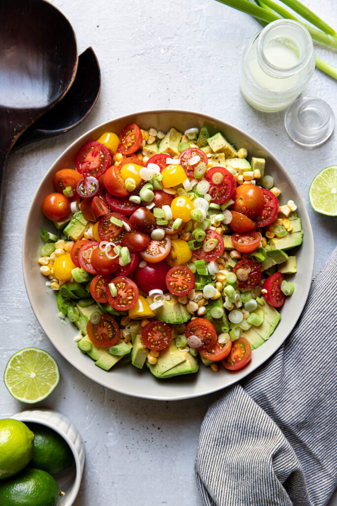 avocado corn and tomato salad in a bowl.