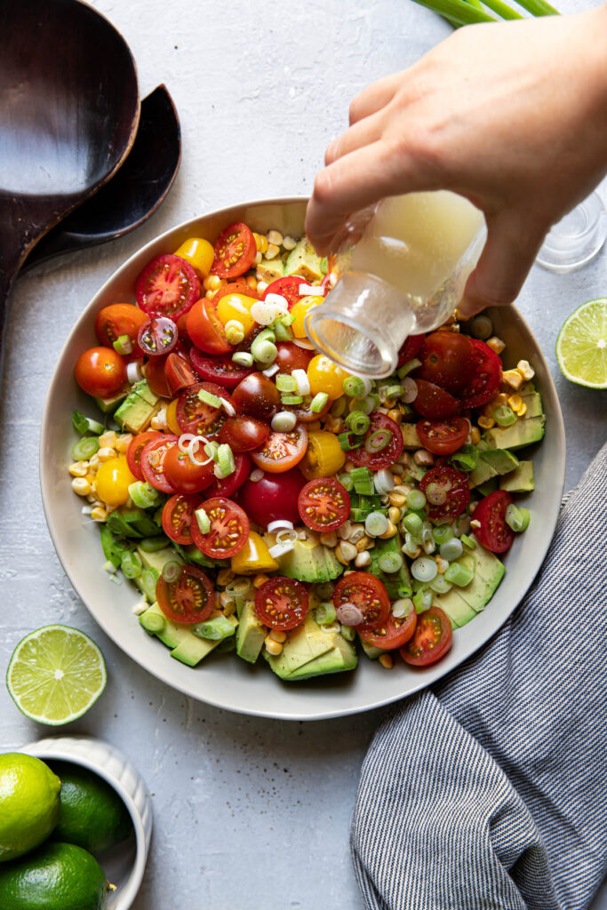 avocado corn and tomato salad in a bowl.