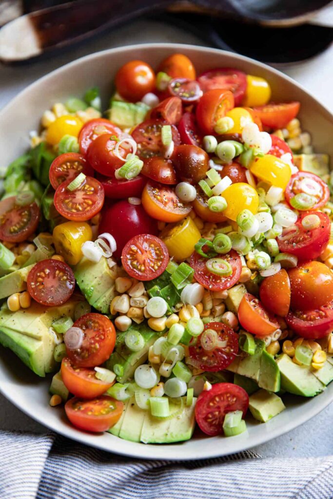 avocado corn and tomato salad in a bowl.