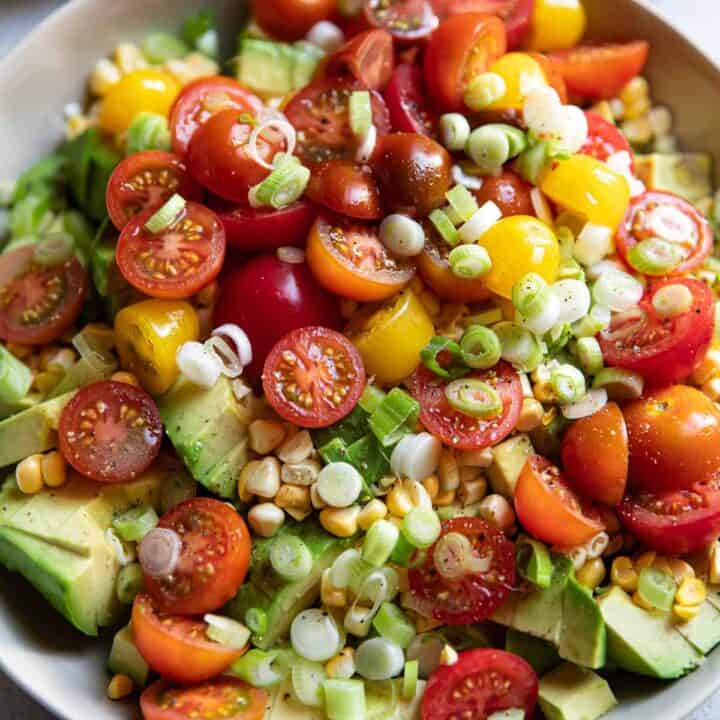 avocado corn and tomato salad in a bowl.