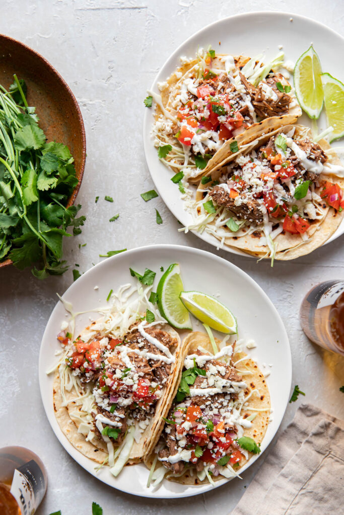 instant pot beef barbacoa tacos on a plate.