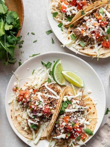 instant pot beef barbacoa tacos on a plate.