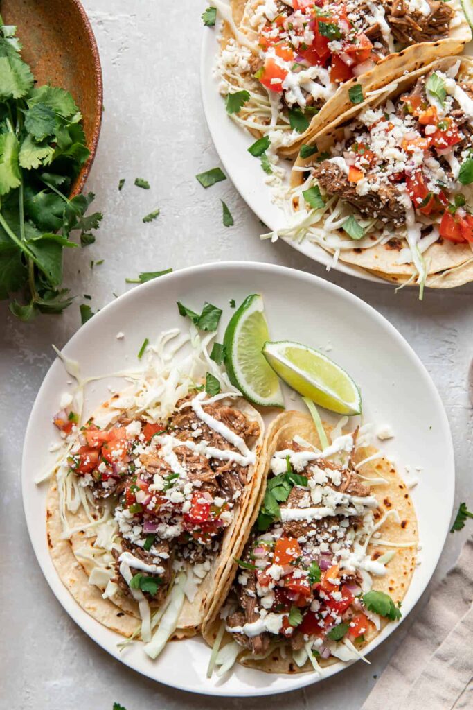 instant pot beef barbacoa tacos on a plate.