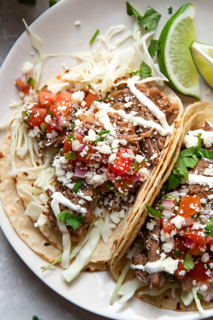 instant pot beef barbacoa tacos on a plate.