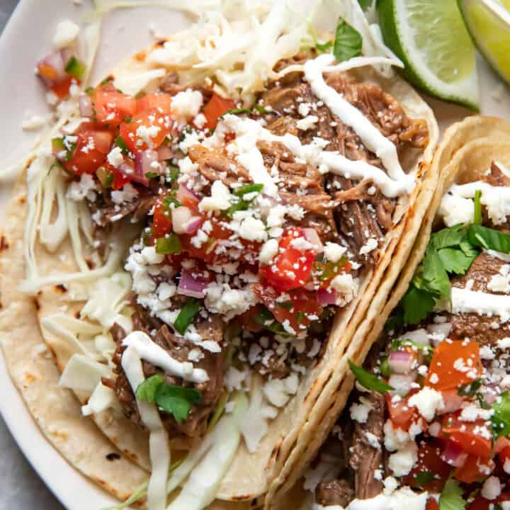 instant pot beef barbacoa tacos on a plate.