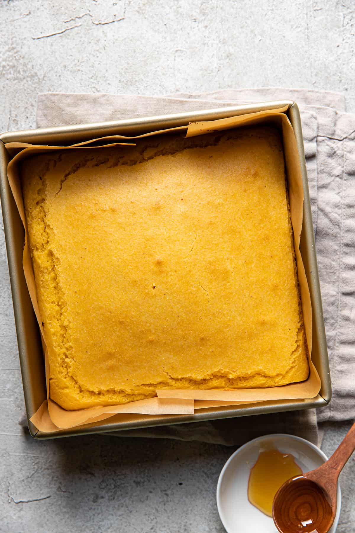 buttermilk honey cornbread batter in a baking pan.