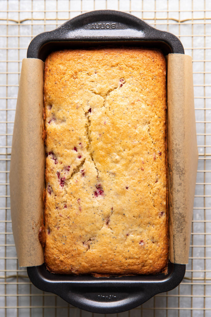 raspberry lemon poppyseed loaf cake in a pan.