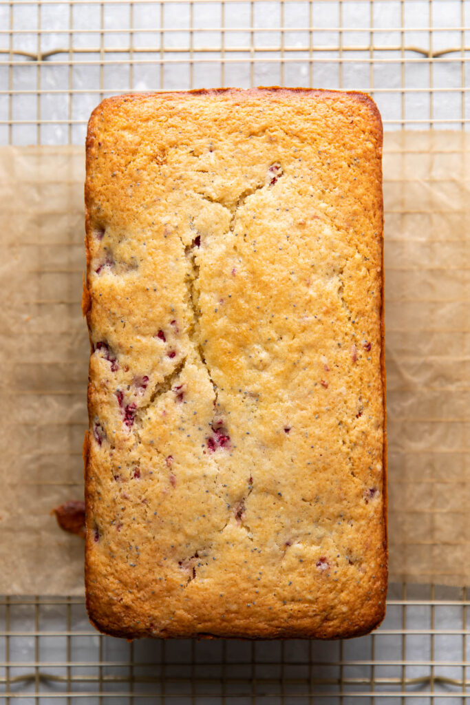 raspberry lemon poppyseed loaf cake in a pan.