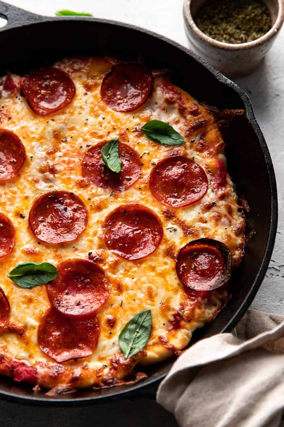 cheese and pepperoni pizza cooked in a cast iron skillet.