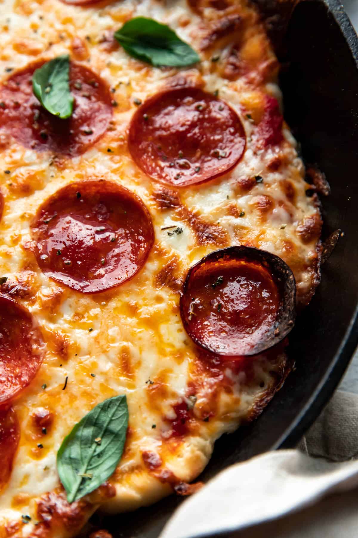 cheese and pepperoni pizza cooked in a cast iron skillet.