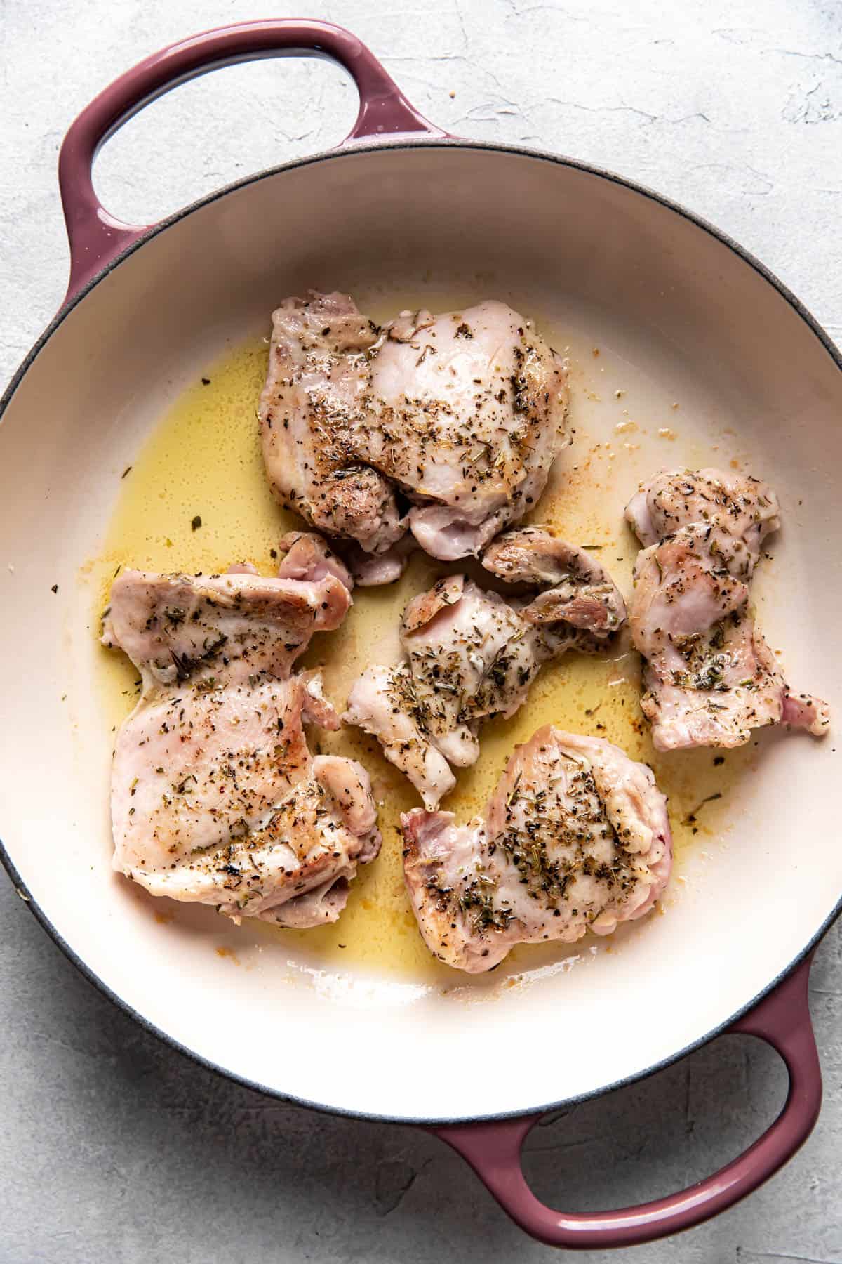 chicken thighs cooked in a saute pan.