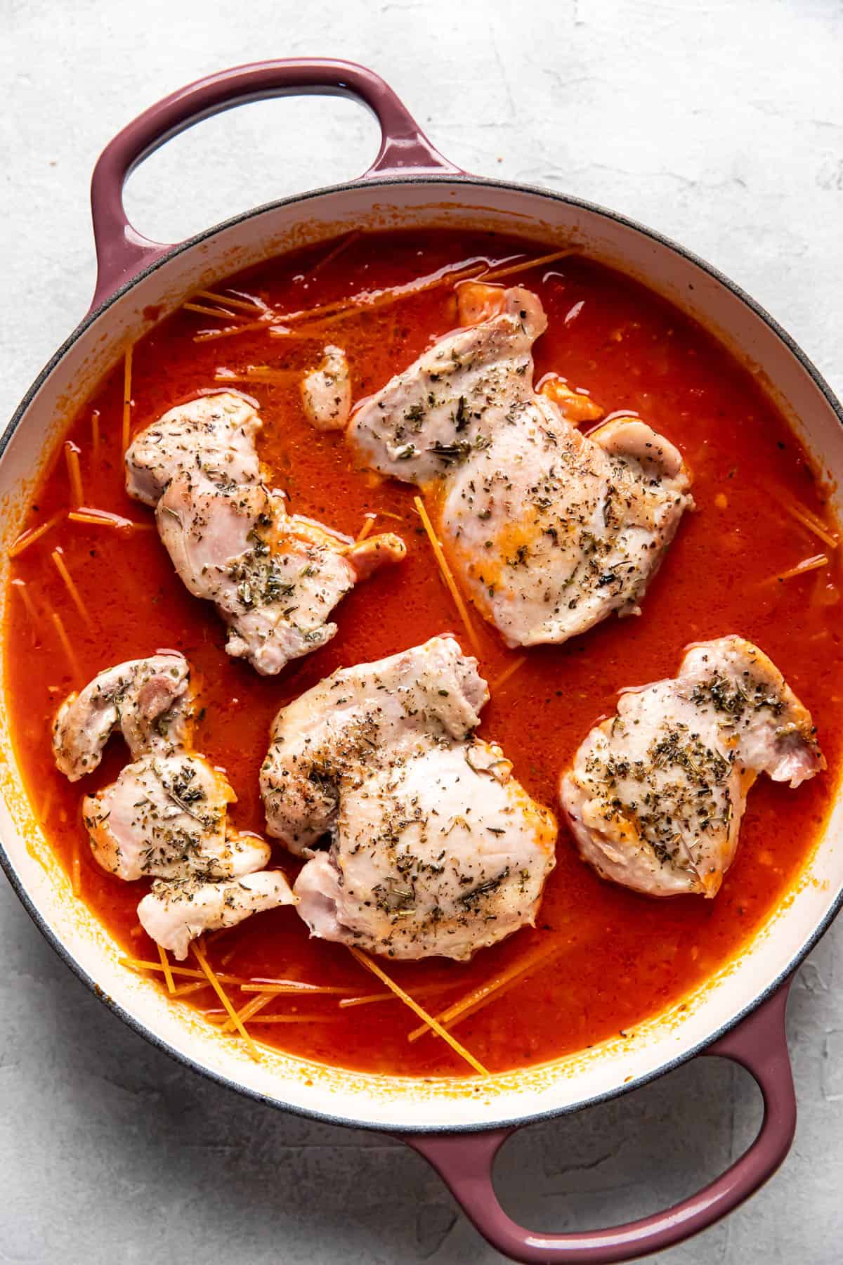 skinny chicken parmesan before cooking in a pan.