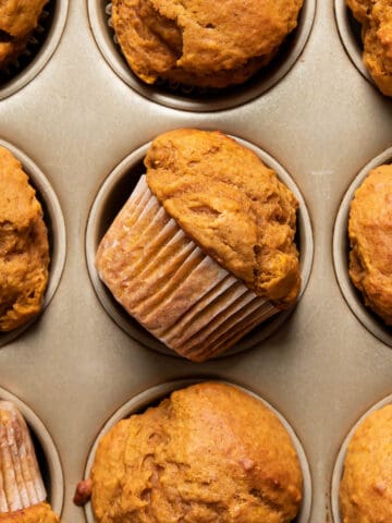 pumpkin muffins in a muffin pan.
