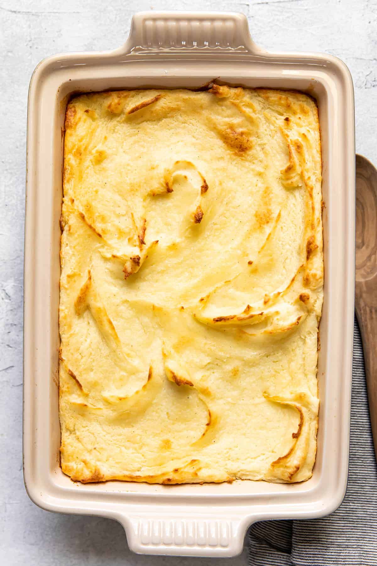 baked mashed potatoes in a baking dish.