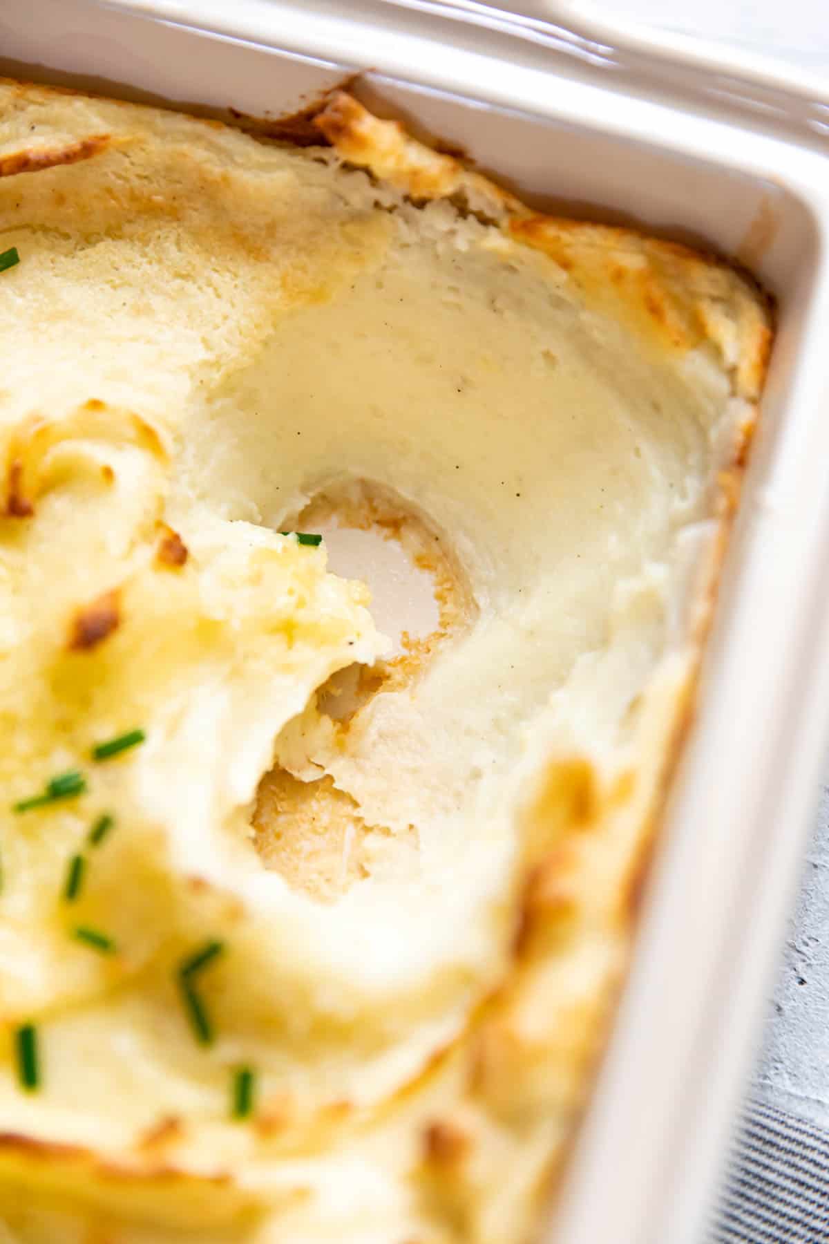 baked mashed potatoes in a baking dish.