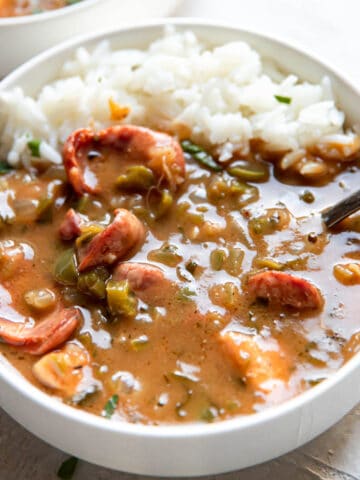 chicken and sausage gumbo in a bowl with rice.