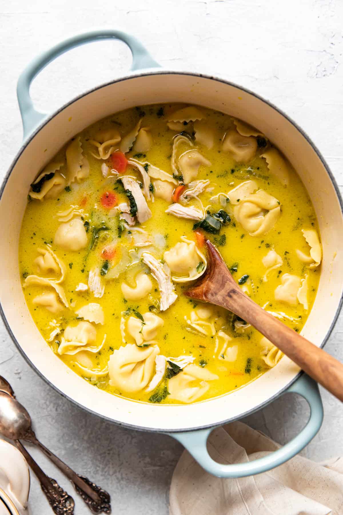creamy chicken tortellini soup in a pot.