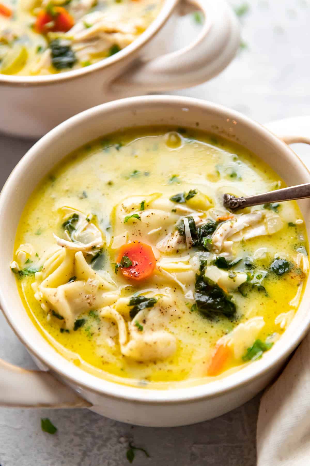 creamy chicken tortellini soup in a bowl.