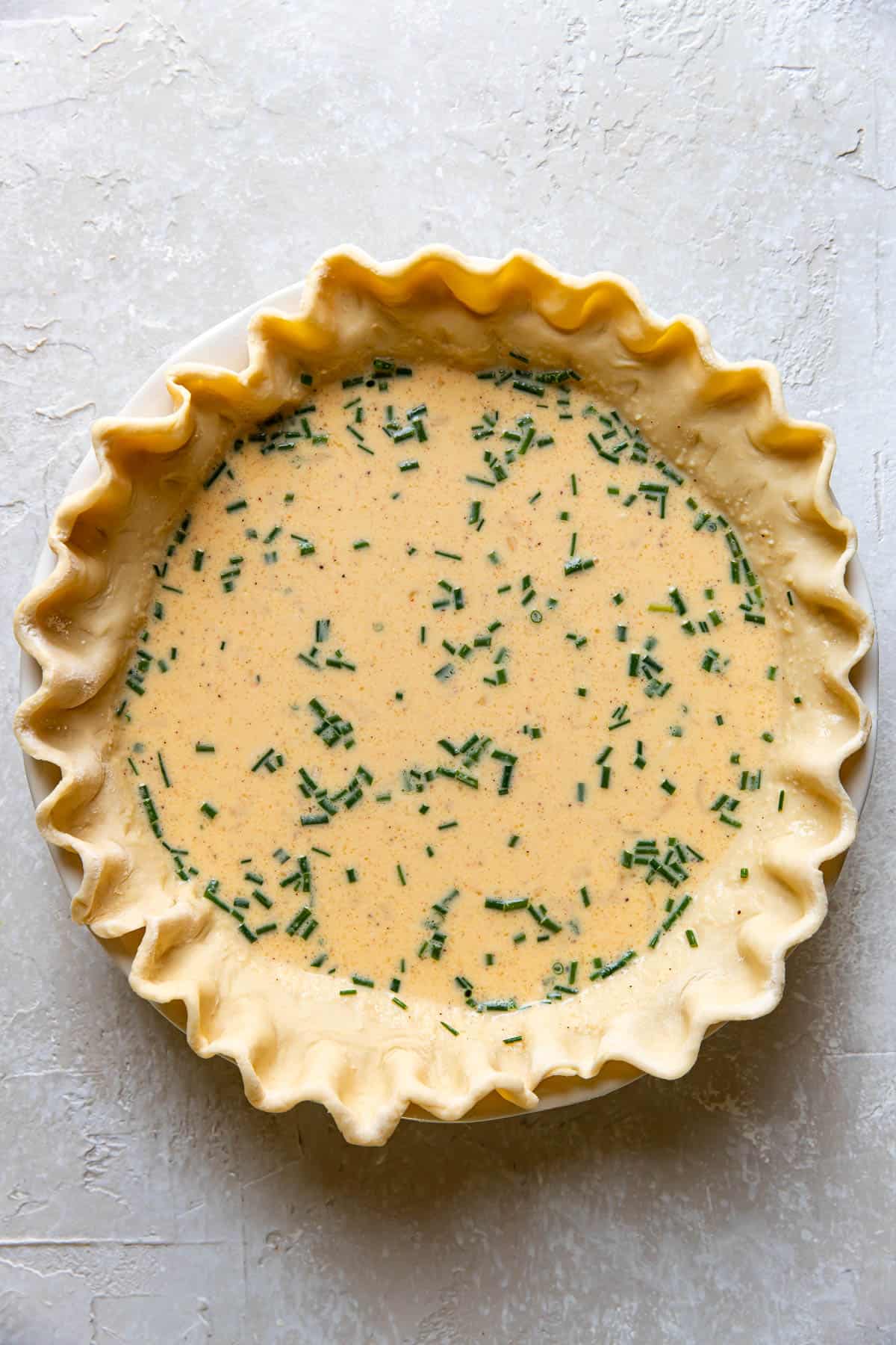 quiche prior to baking in a pie plate.