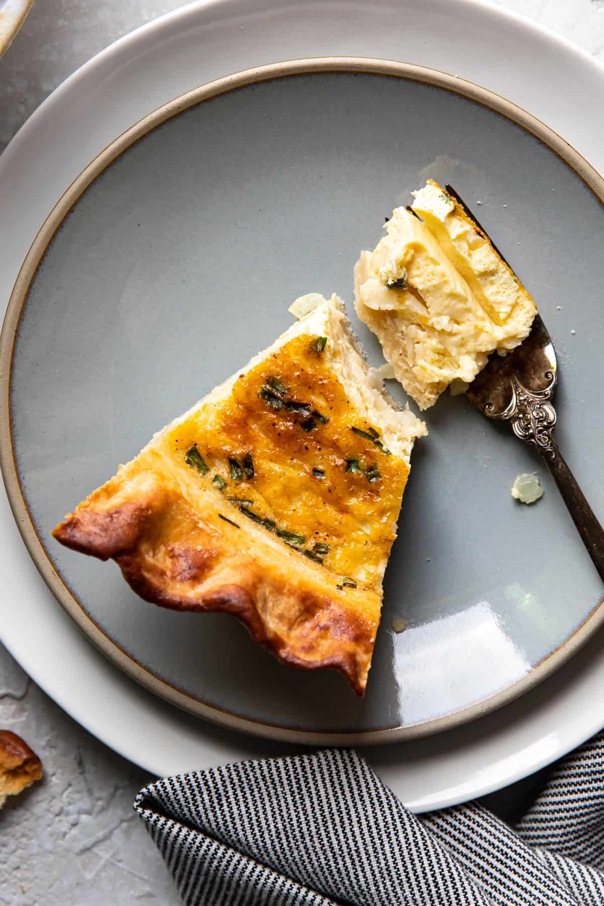 slice of quiche on a plate.