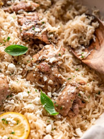 greek chicken and rice in a pan.