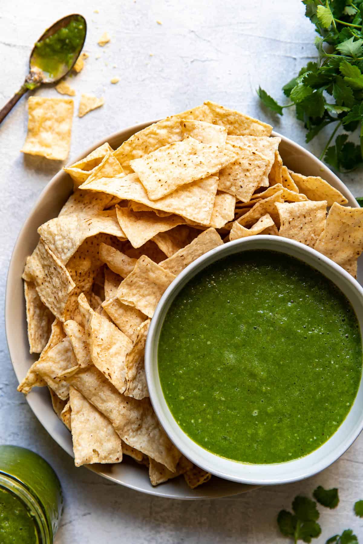 salsa verde in a bowl with chips on the side.