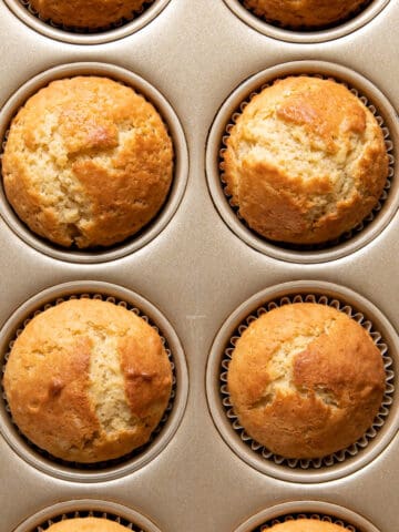 butter and oil muffins in a pan.