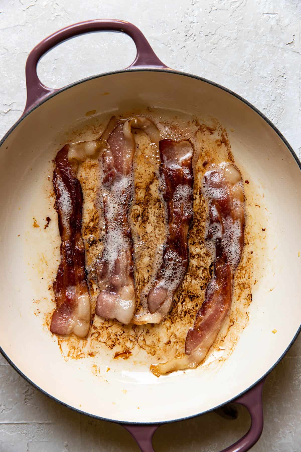bacon cooked in a frying pan.