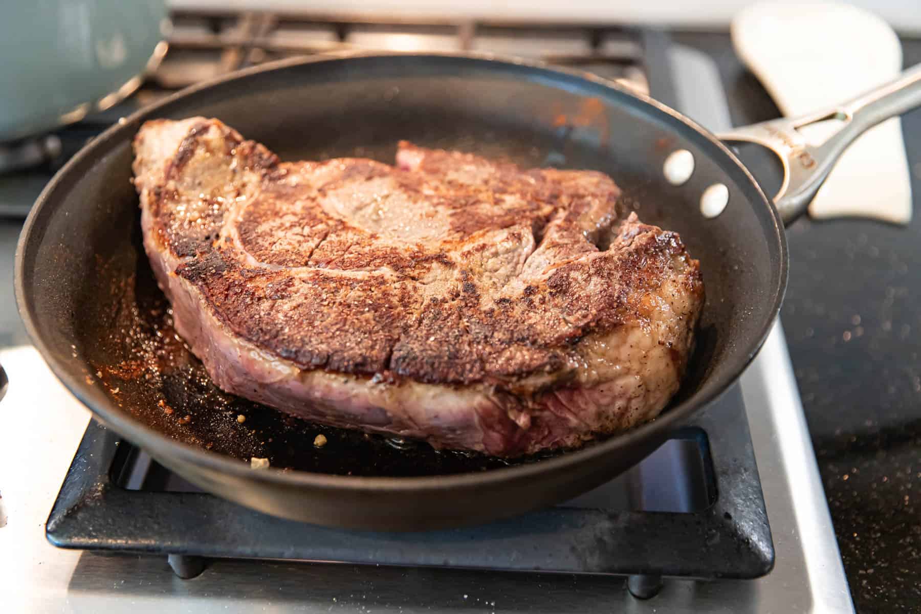 searing chuck roast in a pan.