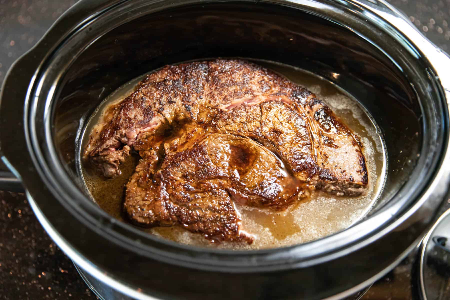 chuck roast in a slow cooker for pot roast.