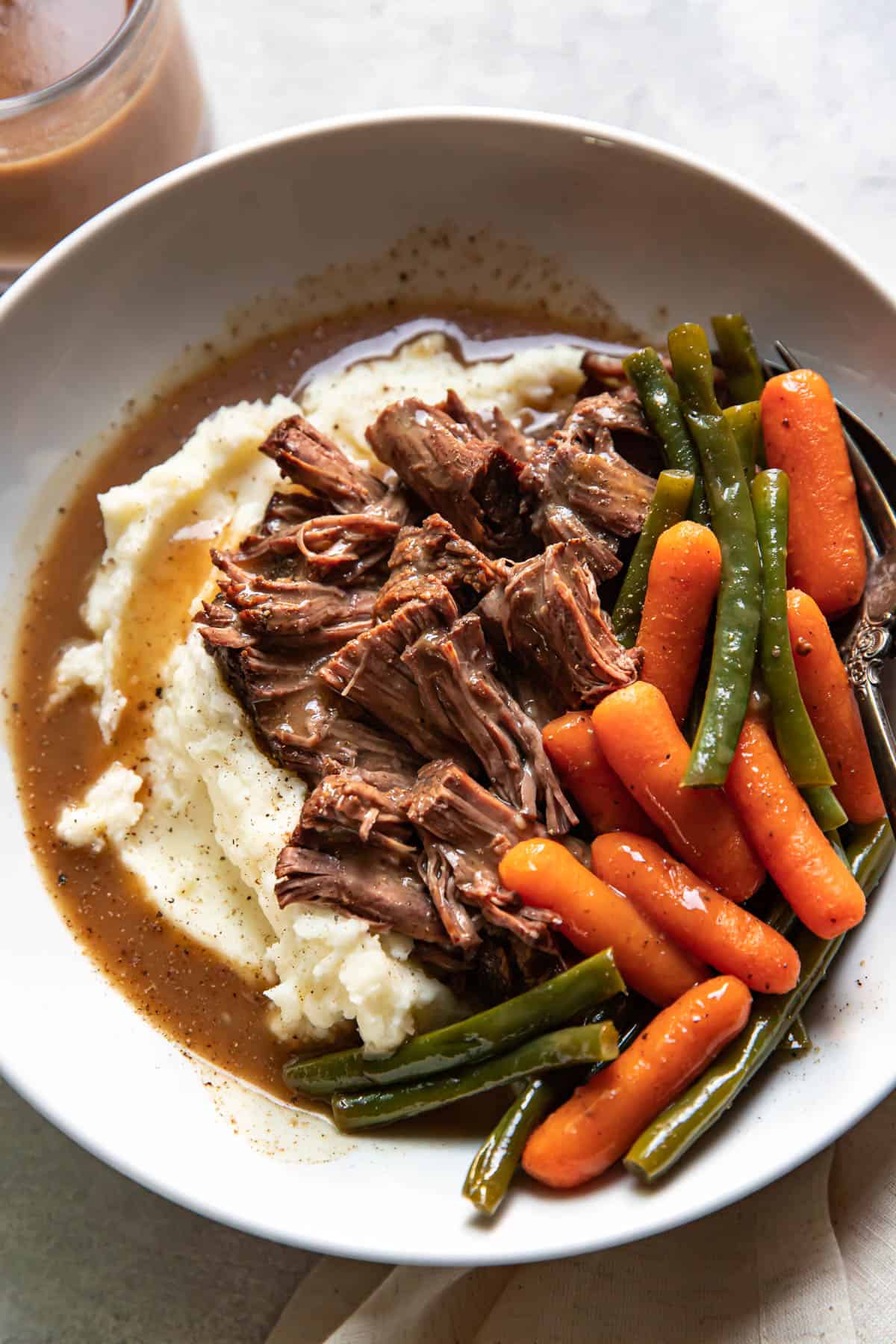pot roast and mashed potatoes in a bowl.