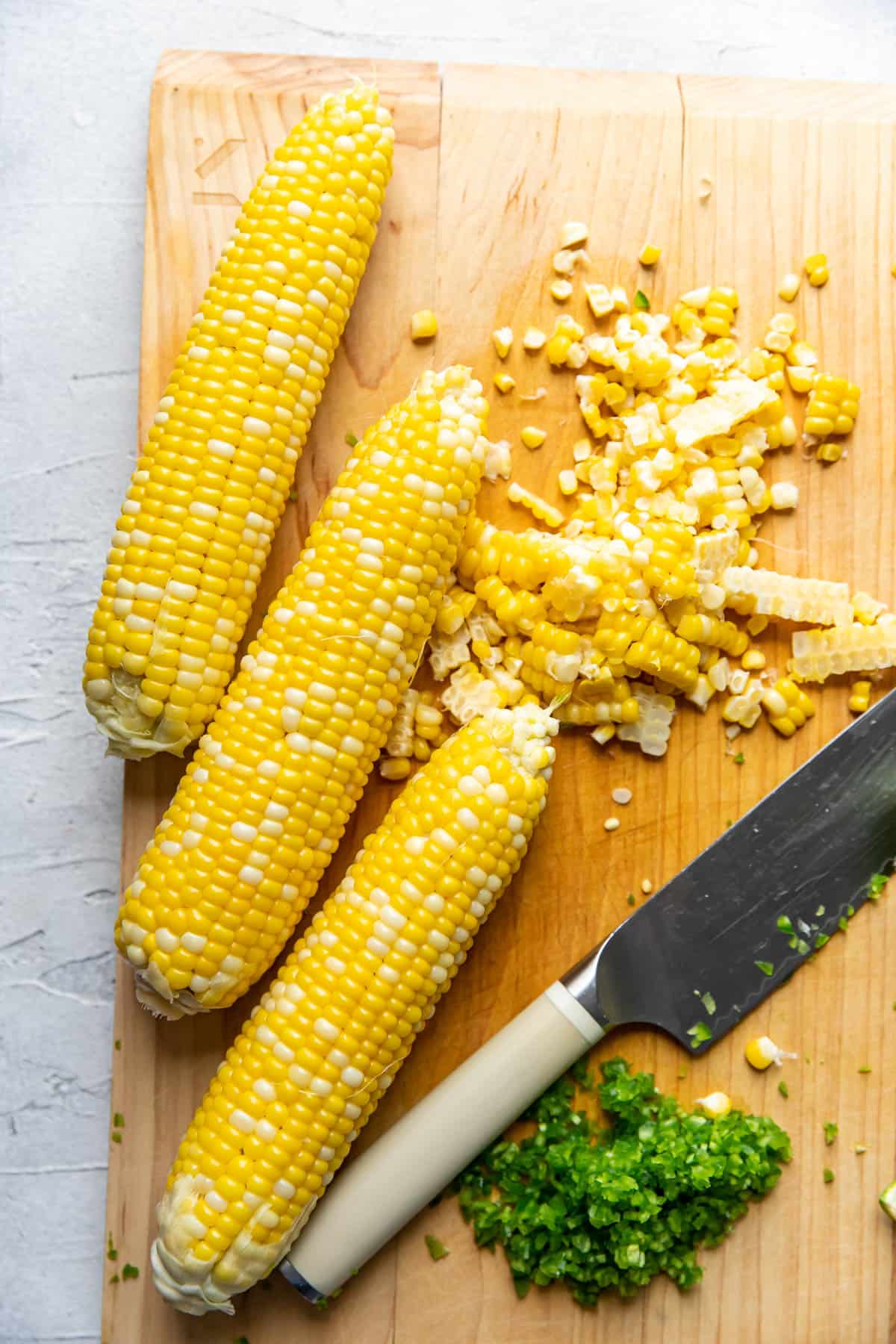 cutting off kernels from corn on the cob.