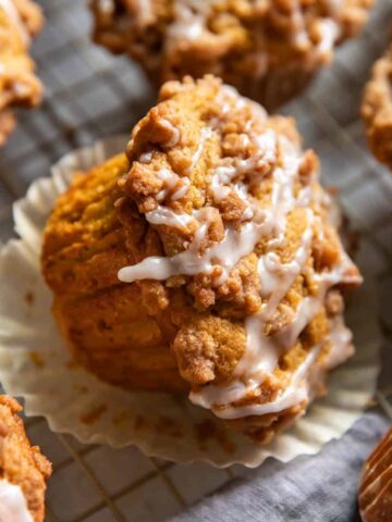 pumpkin cofee cake muffins on a wire cooling rack.
