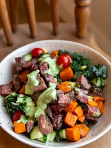 salad in a bowl sitting on a chair.