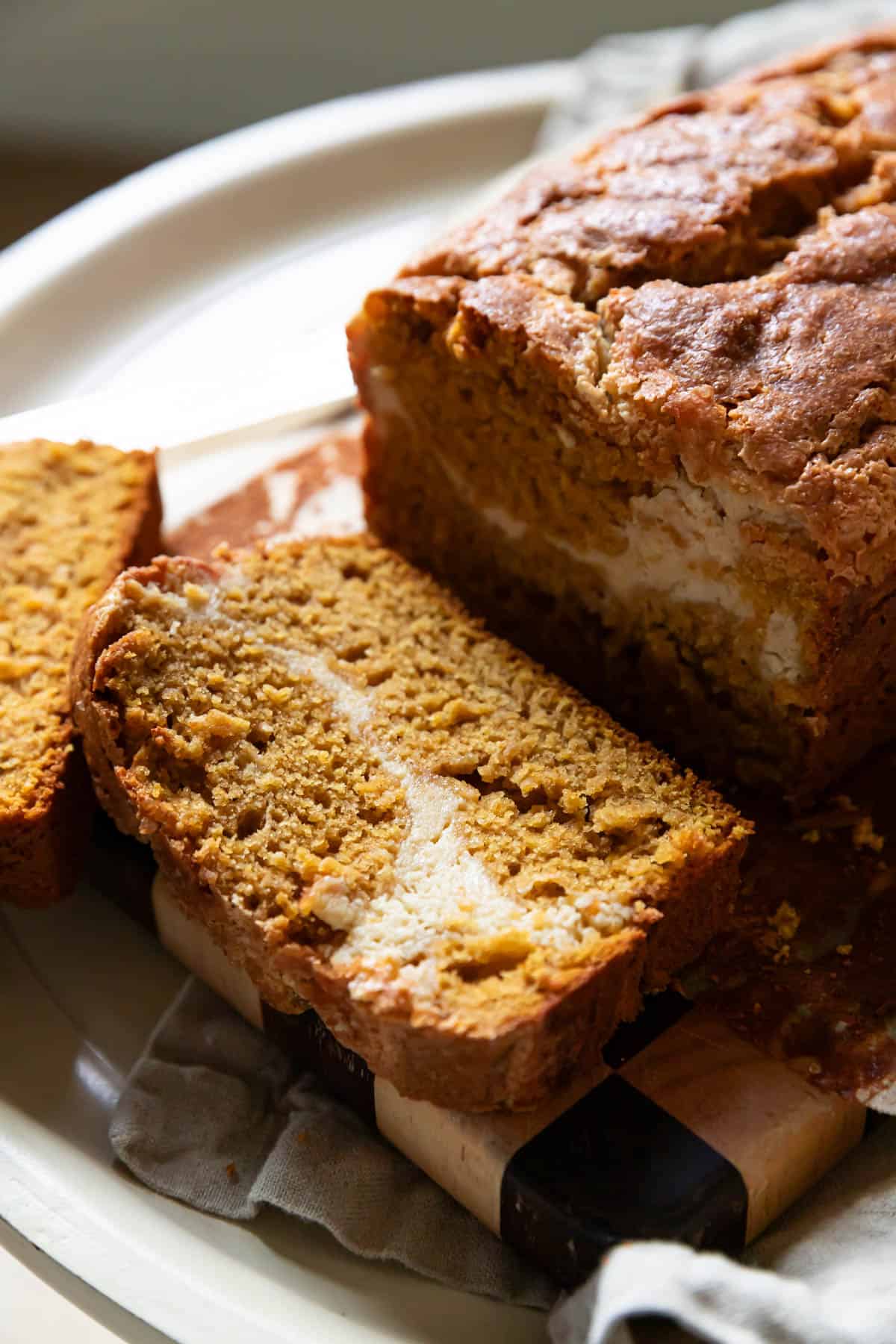 pumpkin cream cheese bread with a slice showing