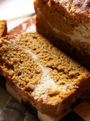 pumpkin cream cheese bread with a slice showing